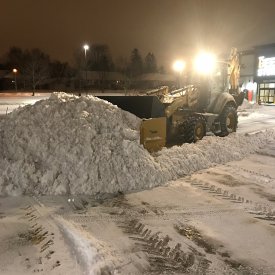 Snow removal clearing at night