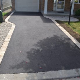 Rounded Interlock Entrance with Trim around Asphalt Driveway